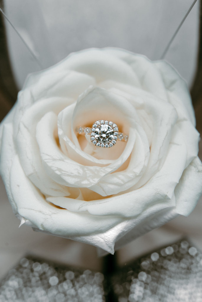 Close up detail shot of Bride's ring in beautiful open white rose in Harvest, Alabama